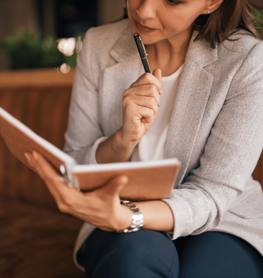 An older and experienced paralegal going through a notebook to find her billable hour missing time at the Bootcamp.