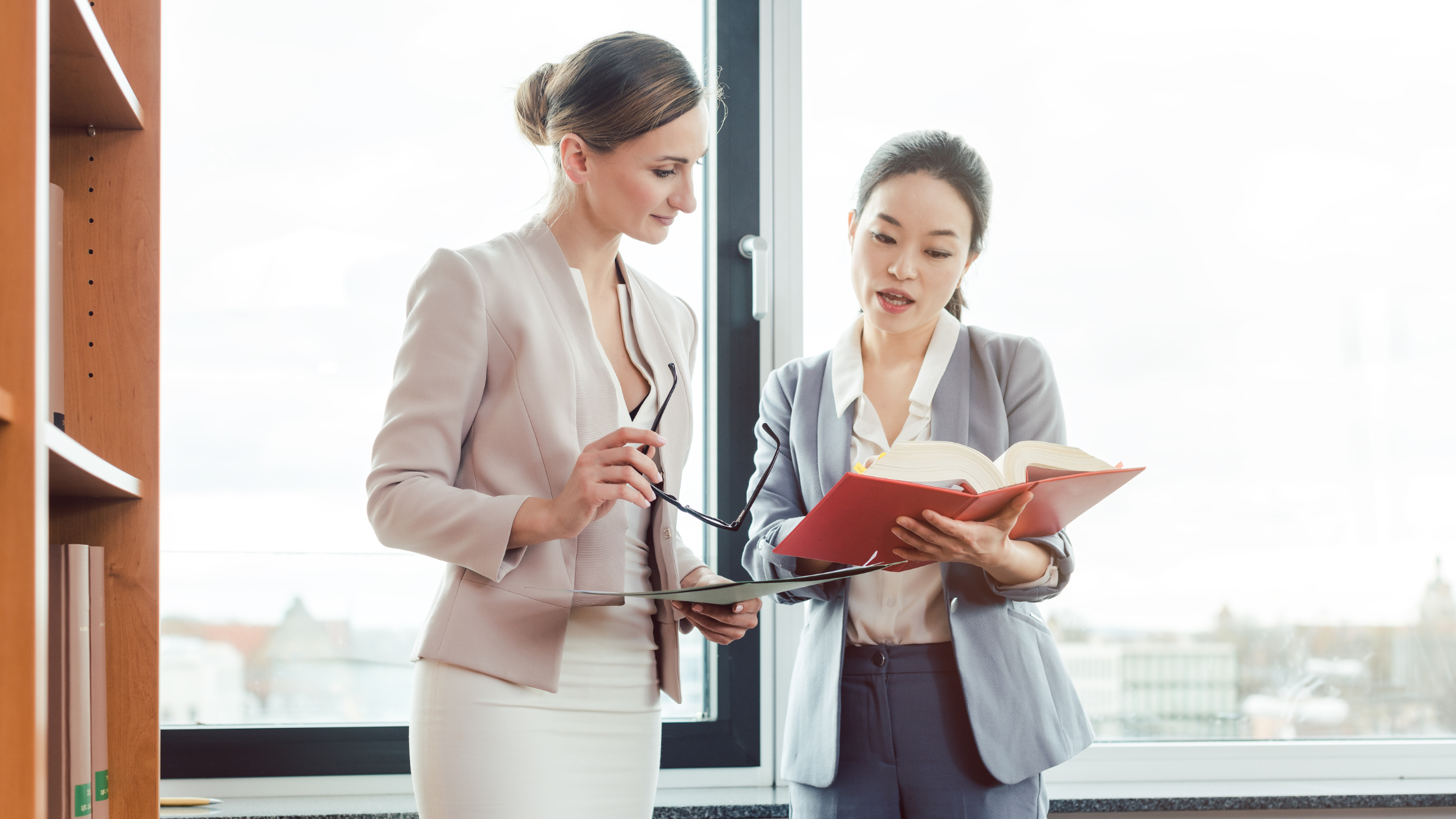 A paralegal explains her work to an attorney while they stand to depict the kind of place every paralegal want to work