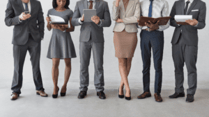 A group of paralegals standing and studying some materials that contain the necessary personal injury paralegal skills.