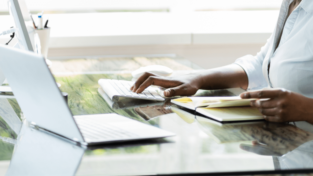 A paralegal typing a digital trial notebook on her desktop computer