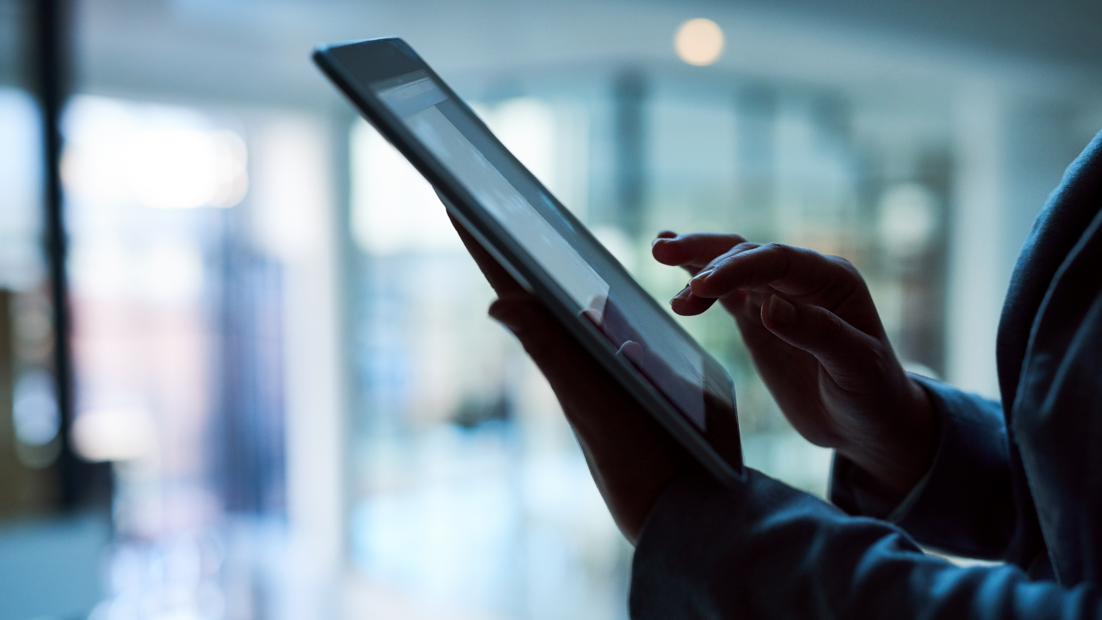 A paralegal works on a tablet to ascertain what extent paralegals can be replaced by AI.