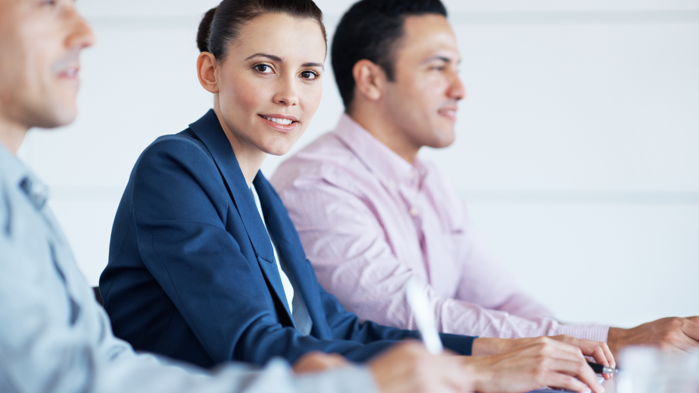 Three paralegals sit at a table and excitedly learn about the alternative paralegal careers.