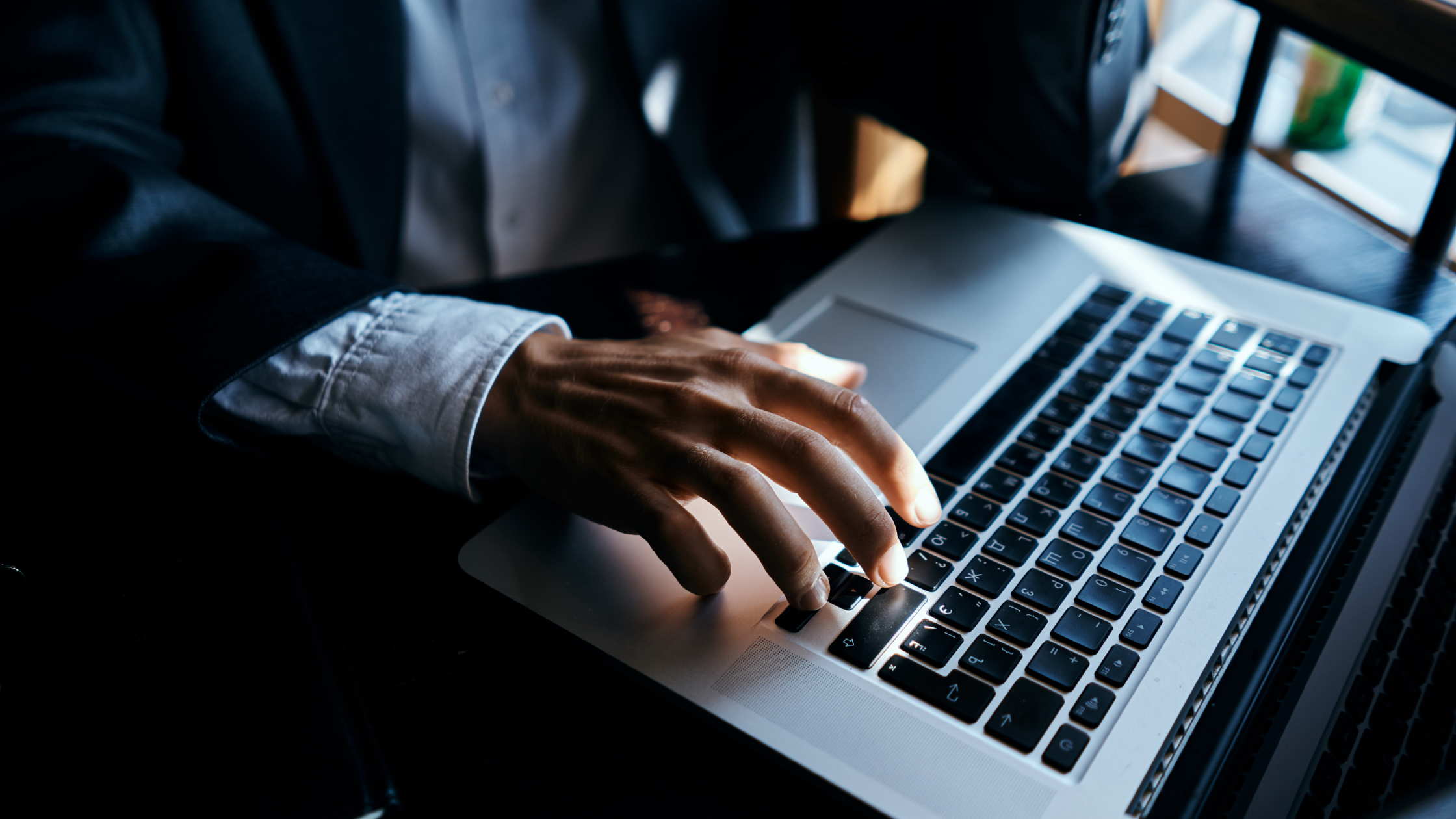 A paralegal's hand tapping at a computer's keypads as he learns and makes his way on the path to eDiscovery certification.