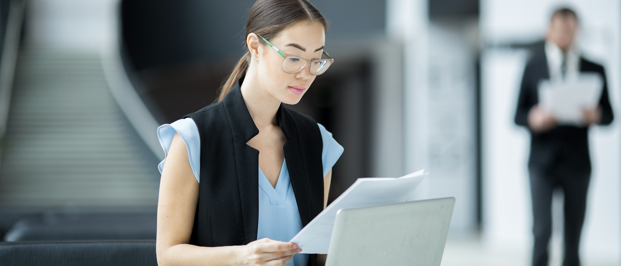 A woman looking over a contract before taking it to the required department