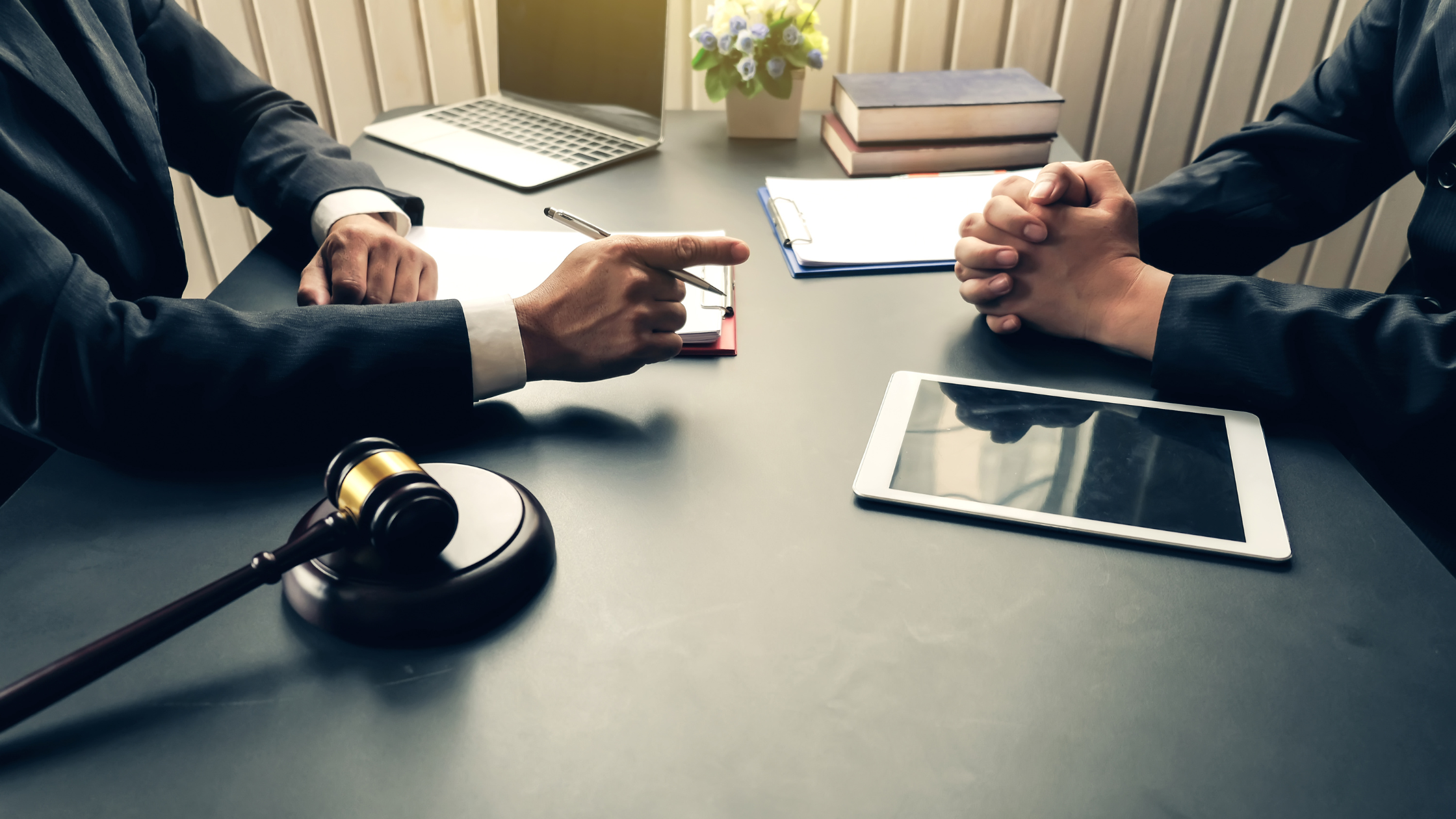 A paralegal sits with his boss to have a discussion about his yelling and how he feels about it.