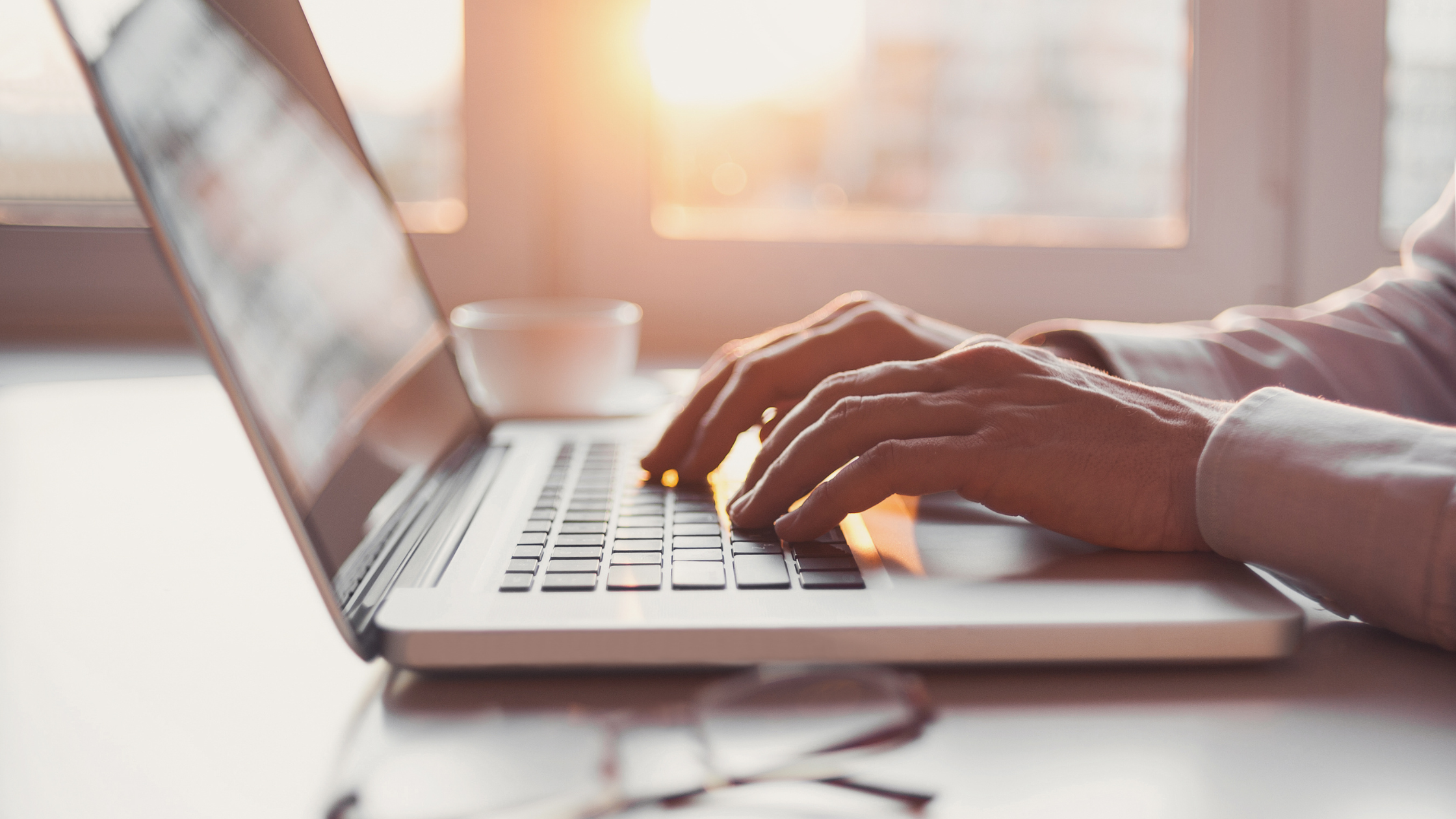 A paralegal sits at a computer and taps at the keyboard as she researches what eDiscovery is.