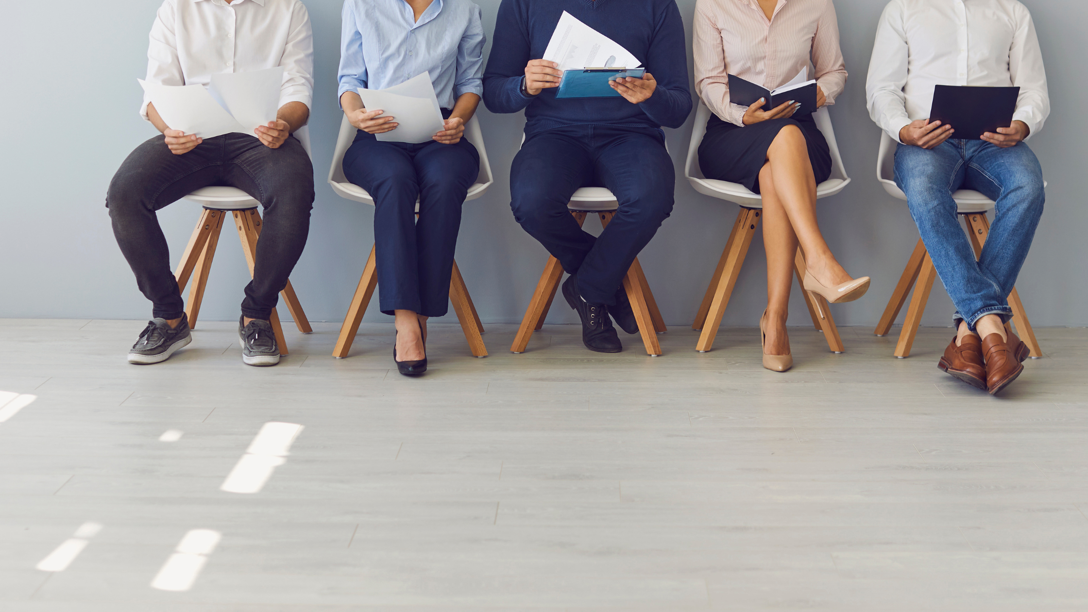 A group of paralegals sitting and waiting for an interview that will help them explore another paralegal practice area.