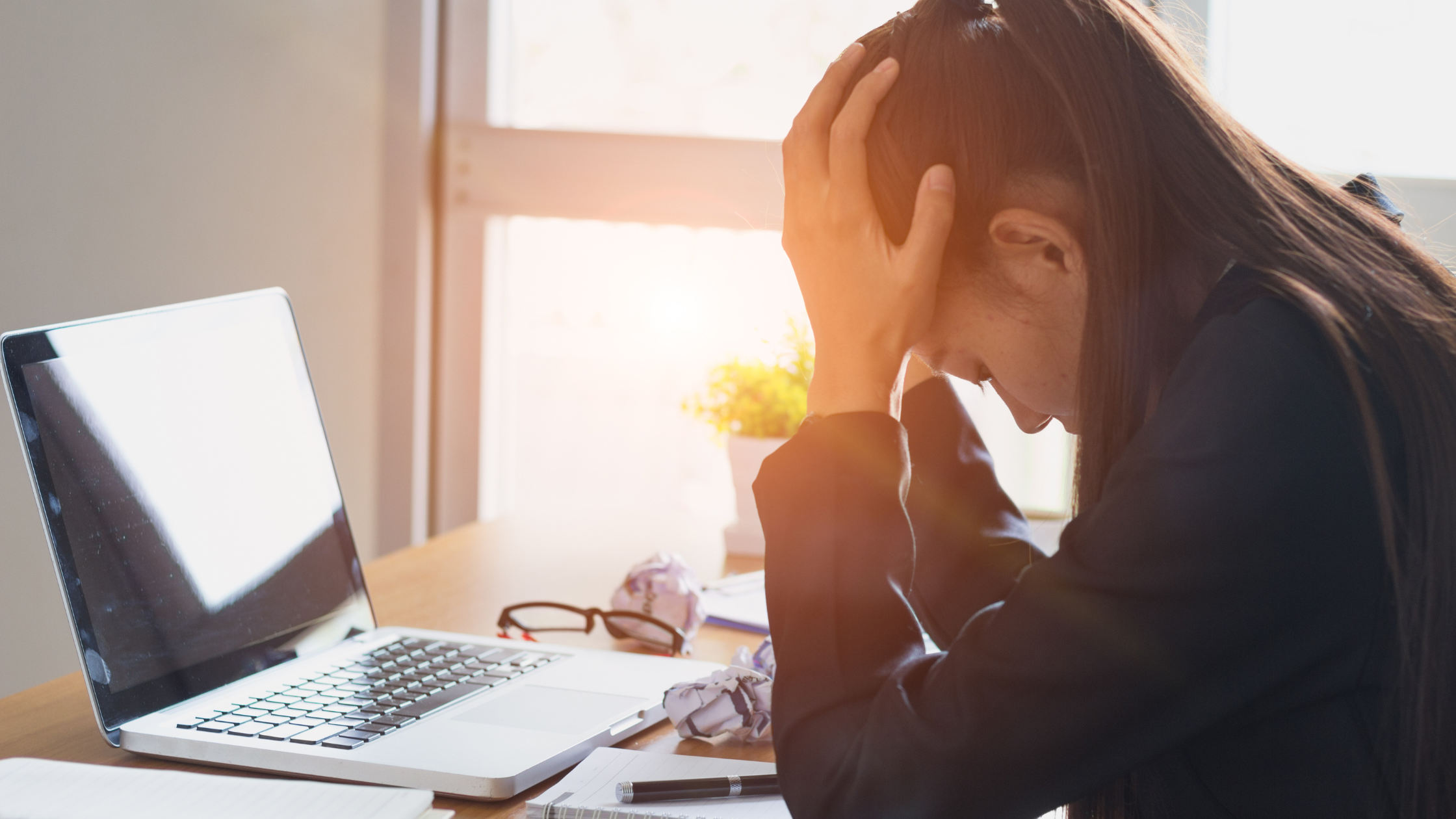 A paralegal holds her head in disappointment over her failure because she didn't understand how failure can benefit her career.