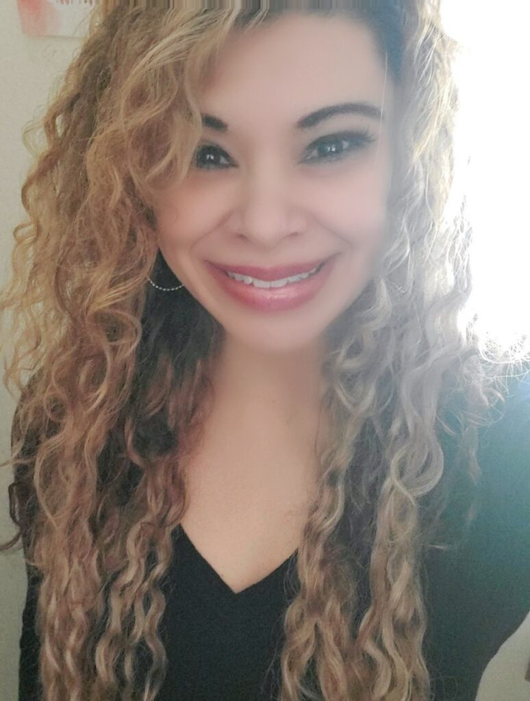 Selfie of Heather Gonzalez with wavy hair and light makeup