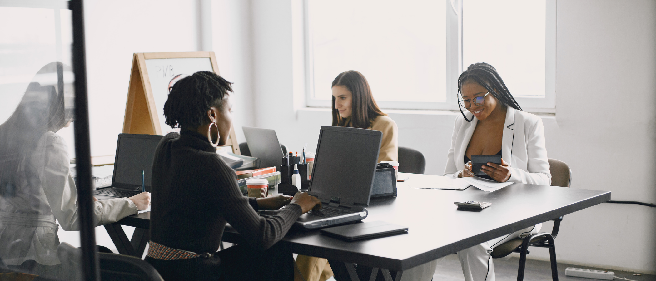 A group of female colleagues working and having fun discussions as they work