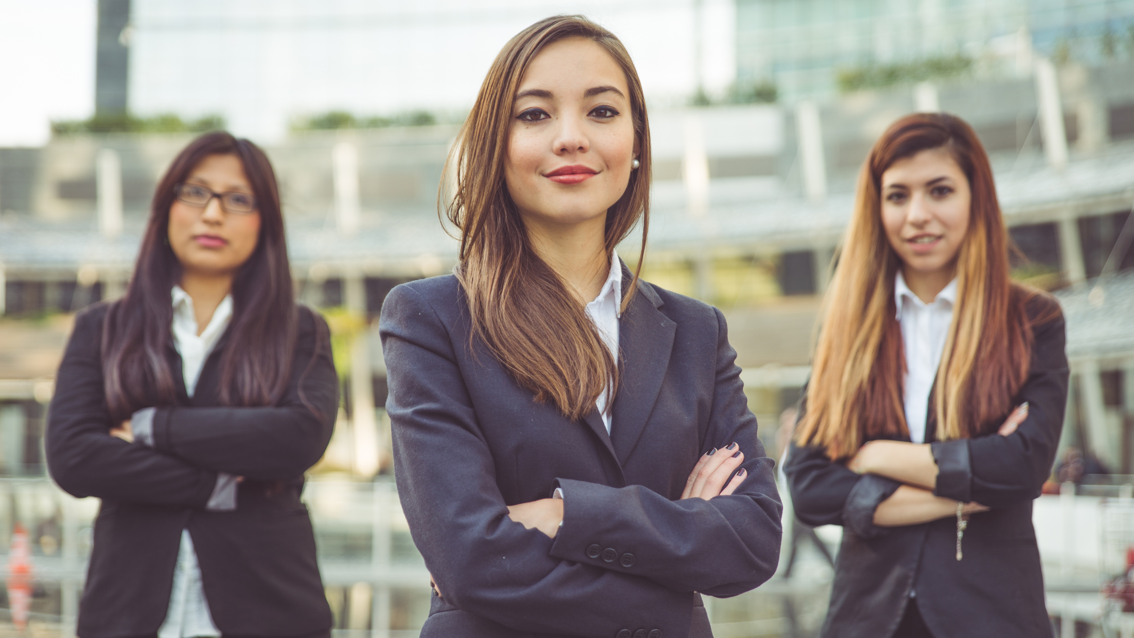 Three new paralegals smile because they understand the skills they need as new paralegals to succeed.