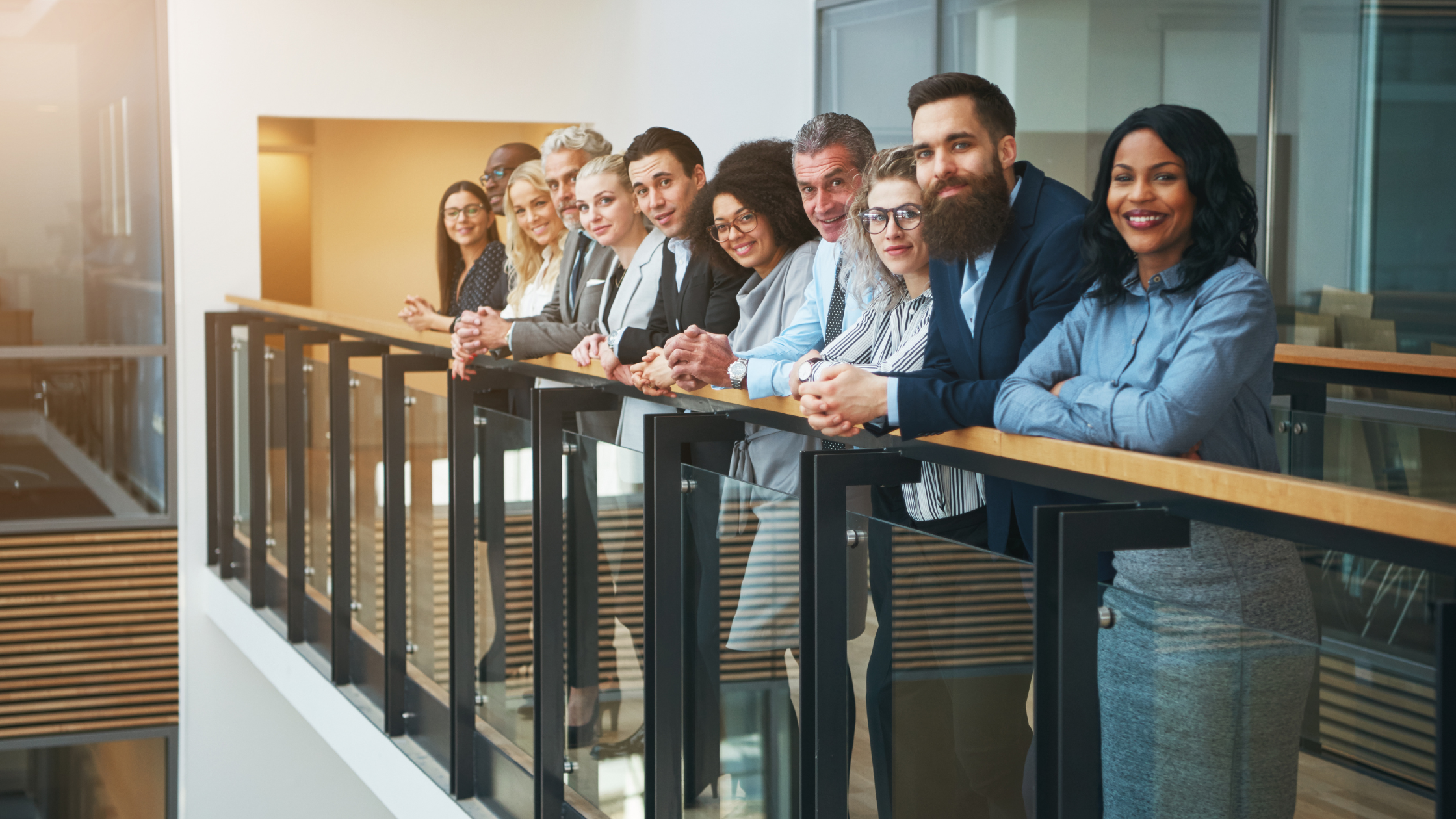 A group of paralegals stand at a railing after determining how long it takes to become a paralegal.