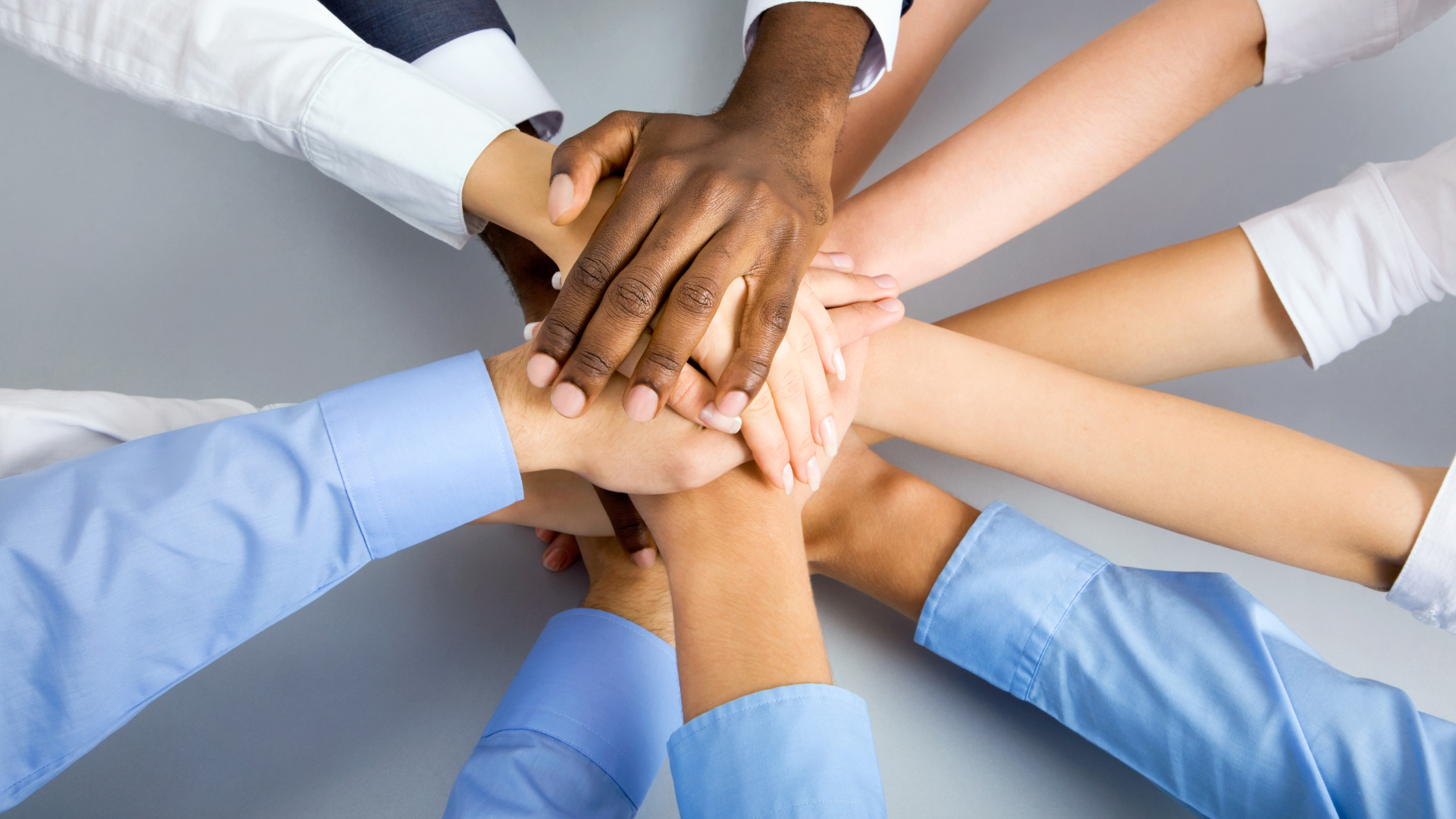Paralegals hold their hands to form a strong link and a knot to show the importance of their role in a law firm.