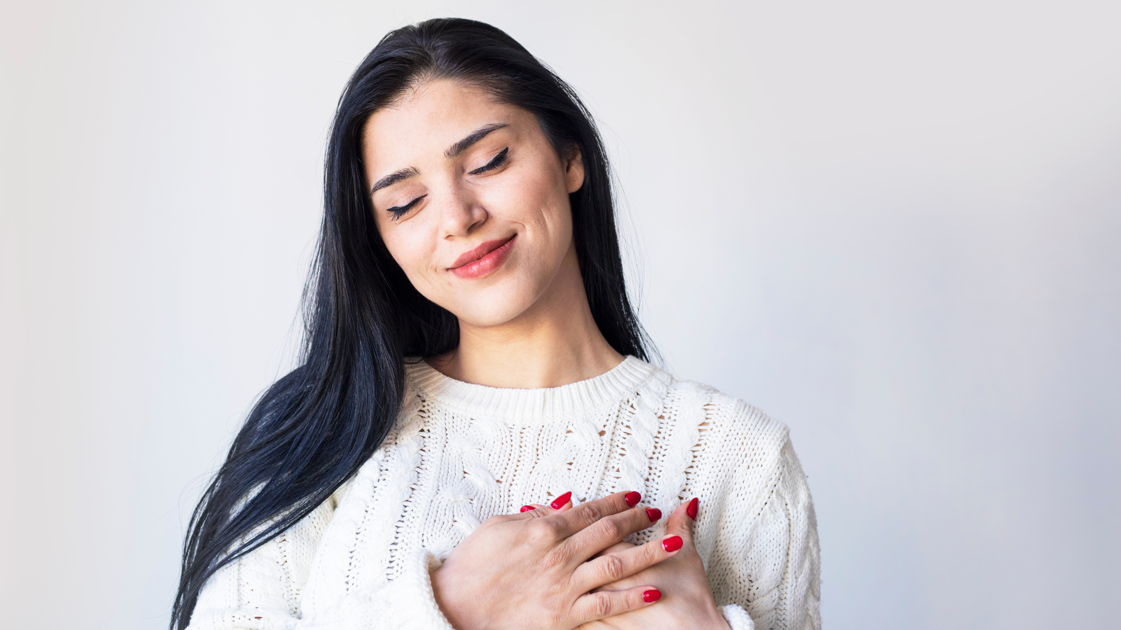 A paralegal smiles in a relaxed state to show the effectiveness of self-care to reduce paralegal stress.