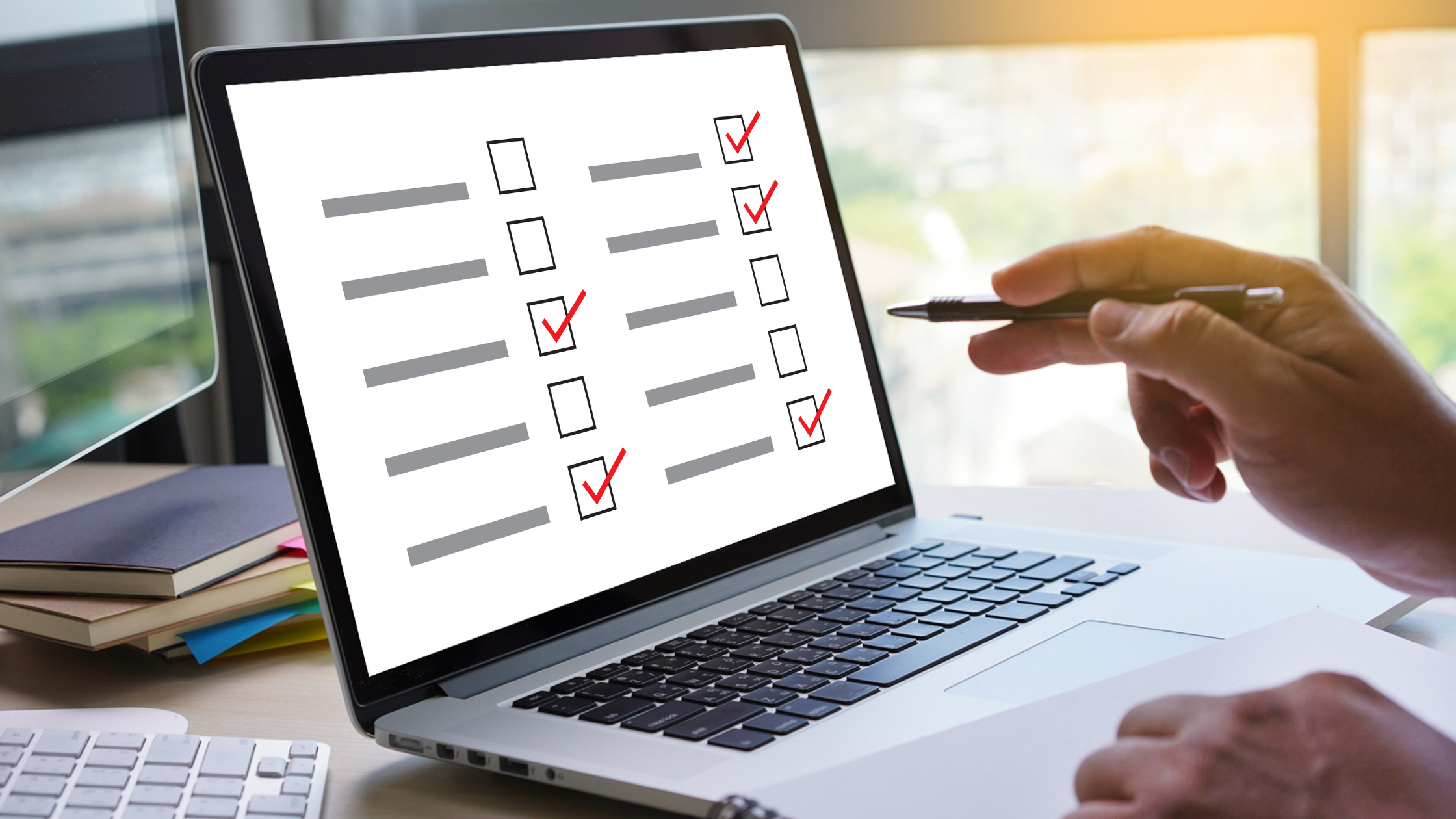 A paralegal sits before a computer screen showing boxes with red ticks to show the results of the paralegal survey.