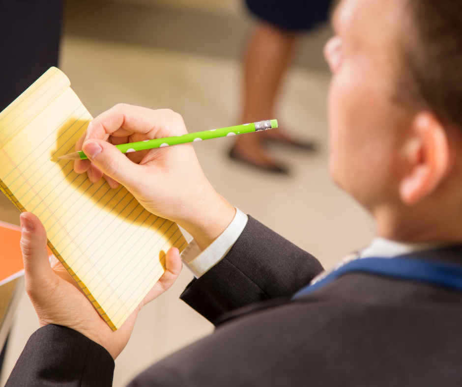 A paralegal jotting salient points during a discussion with an attorney to get the most out of a paralegal internship.