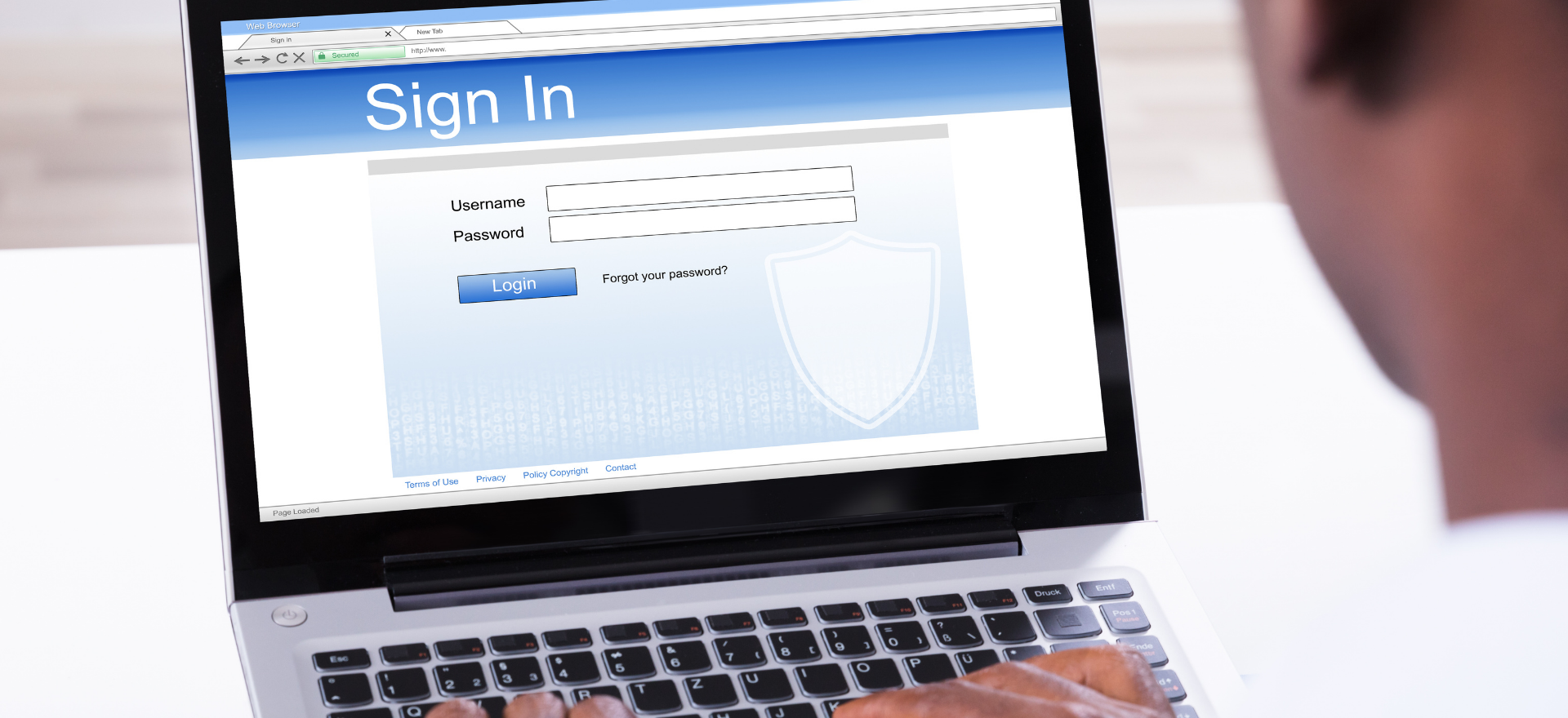 Man signing into a website with a laptop requesting username and password