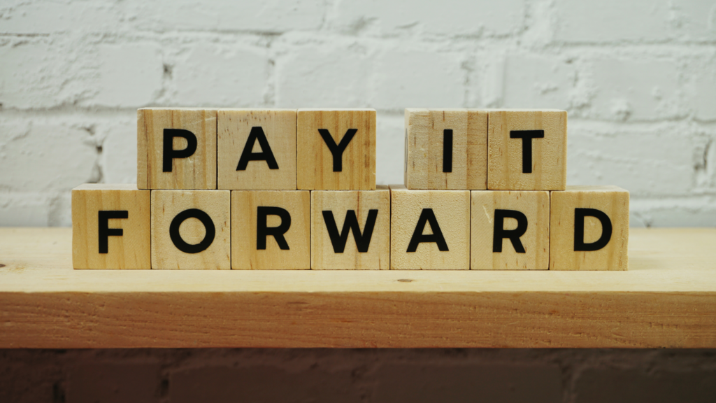 An image of lettered squares that spell out the phrase, pay it forward, for the paragel on fire podcast, episode 6