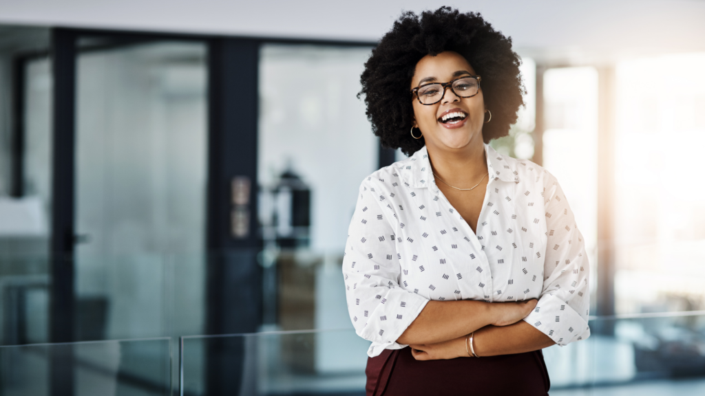 A paralegal smiling; exhibiting a positive mindset as one of the ways to overcoming obstacles to land your dream paralegal job.