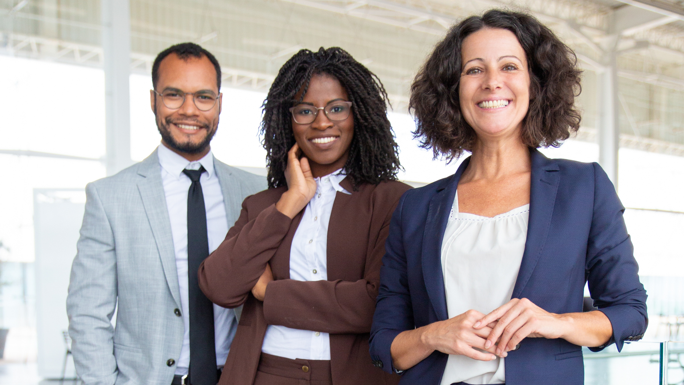 Three paralegals with confident smiles and postures showing how to be confident as a paralegal.