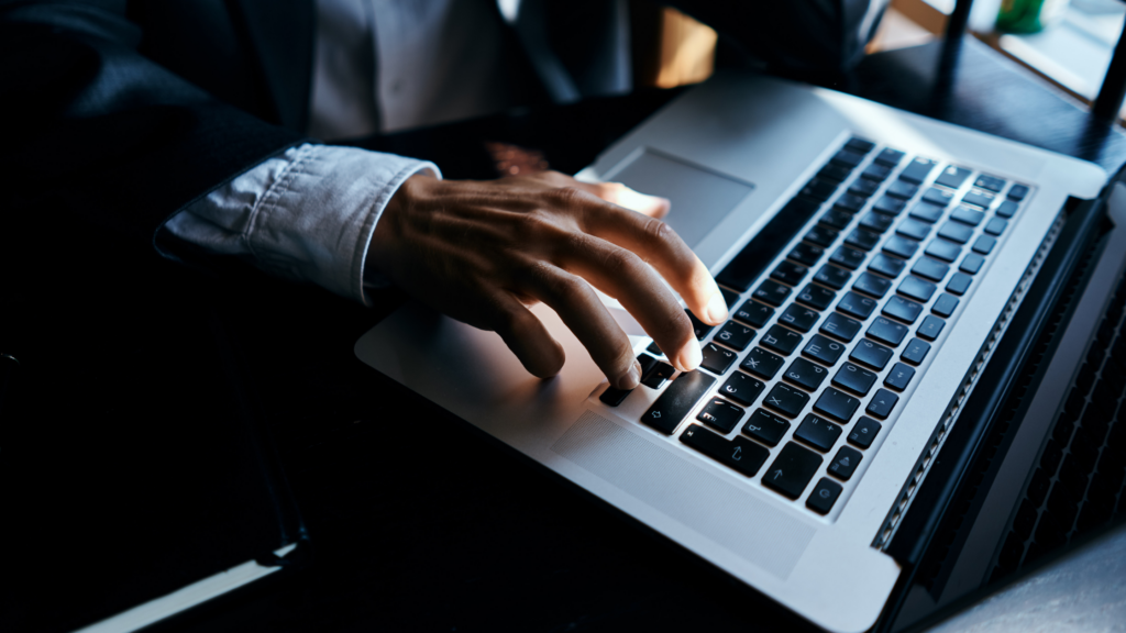 A professional paralegal sitting at a computer and applying some of the litigation technology tips for paralegals to his work.