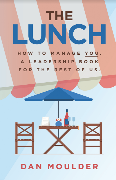 The Lunch Cover page sporting a table with drinking glasses, a wine bottle, and a menu, and two chairs under an umbrella.