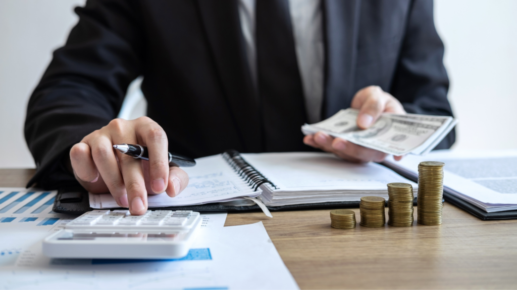 A paralegal holds cash and records their disbursement in a notepad to effect a fasttrack disbursement after settlement.